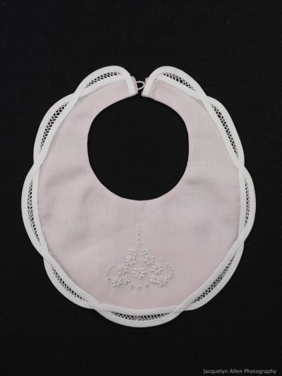 Faggoted scallopped edged bib with satin stitch and eyelet embroidery